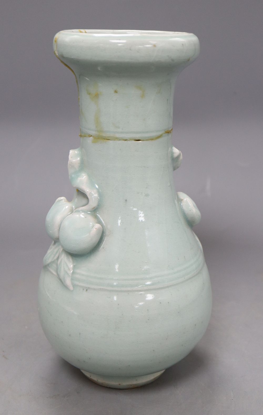 A 17th century Chinese celadon glazed vase, height 26.5cm (a.f) and a pin dish